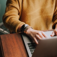 Person focused while working on a laptop