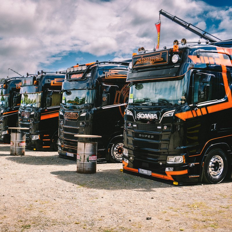 Row of parked freight trucks in a fleet yard