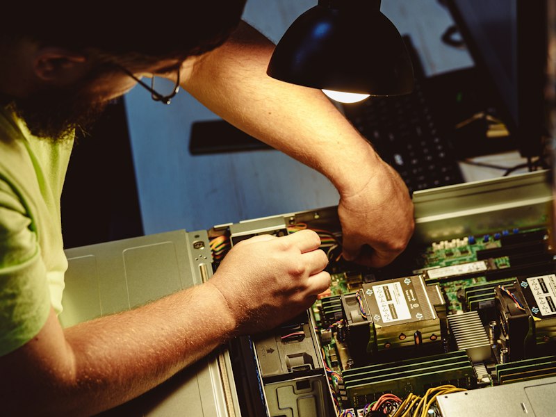 Technician repairing a computer server